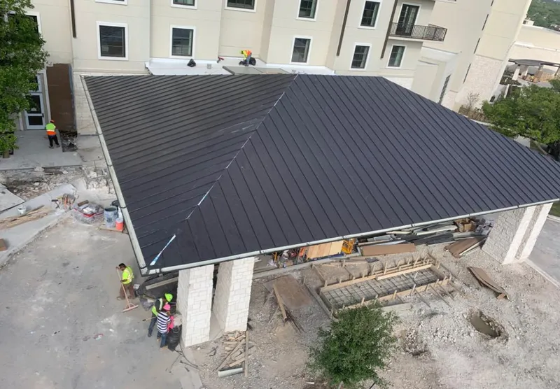 Metal roofing installation team working on a commercial building in Buckeye